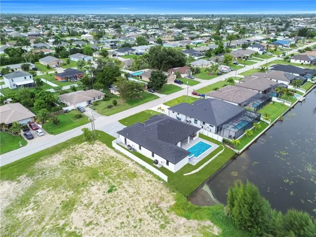 Aerial view of residential area featuring a nearby body of water