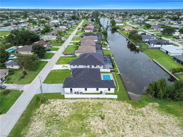 Aerial view of residential area featuring a large body of water