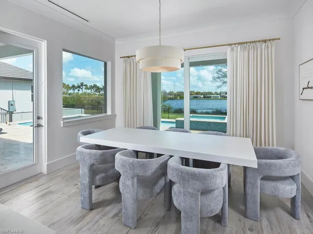 Dining area right off of kitchen, overlooking outdoor patio and lake