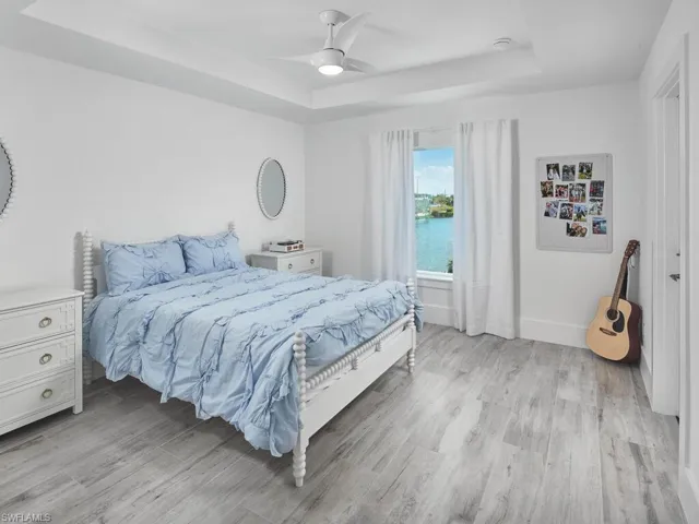 Guest bedroom two with tray ceilings, and lake views