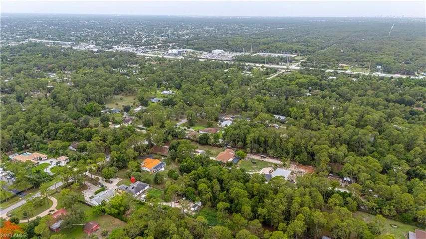 Aerial overview of property's location featuring a forest