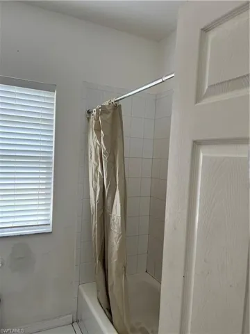 Full bathroom with shower / bath combo with shower curtain