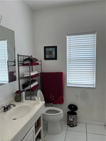 Bathroom with tile patterned floors and vanity