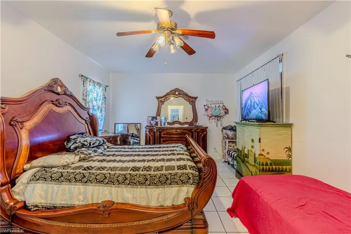 Bedroom featuring light tile patterned flooring and a ceiling fan