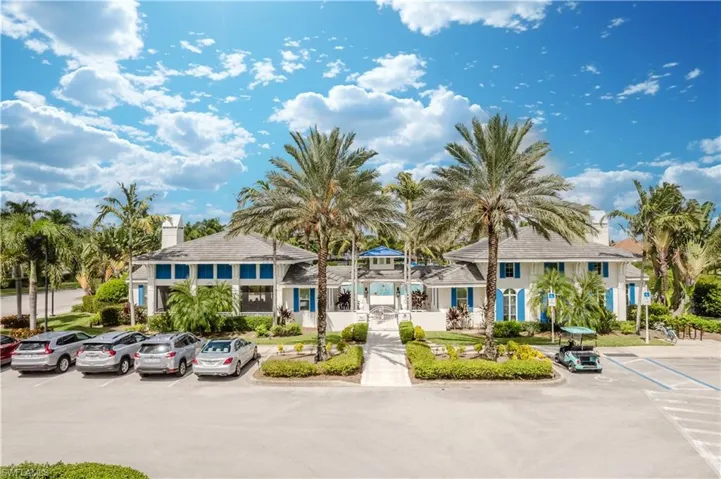 View of building exterior with uncovered parking