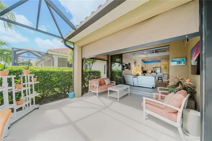 View of patio featuring glass enclosure and a sunroom