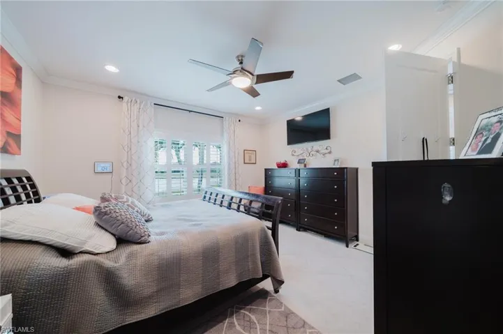 Bedroom with crown molding, a ceiling fan, light tile patterned floors, and recessed lighting