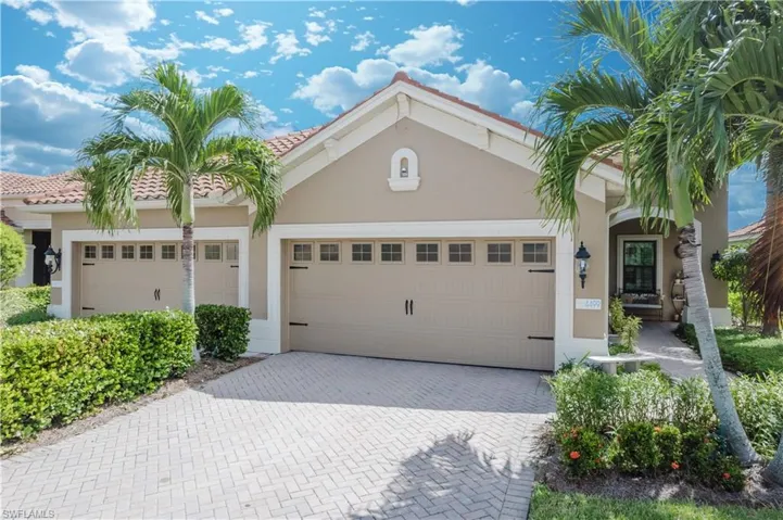 Mediterranean / spanish house with stucco siding, decorative driveway, a garage, and a tile roof