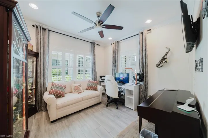 Office with wood finished floors, recessed lighting, crown molding, and ceiling fan