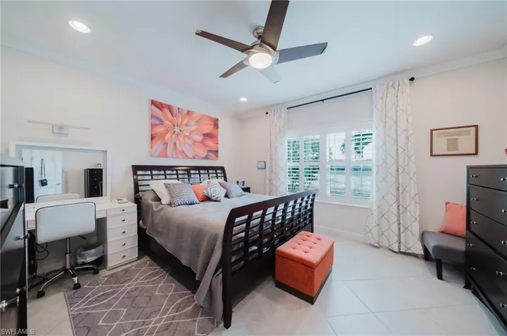 Bedroom featuring ornamental molding, light tile patterned floors, a desk, a ceiling fan, and recessed lighting