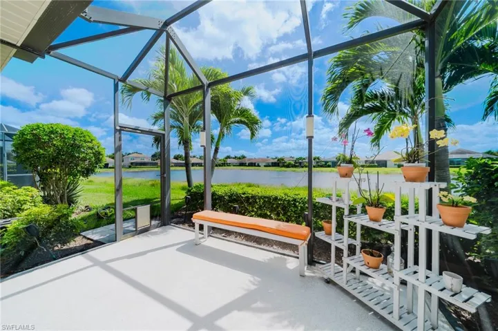 View of patio / terrace featuring a lanai, a water view, a sunroom, and a residential view