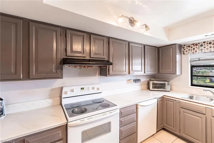 Corian Counters, tile floor, wood cabinets