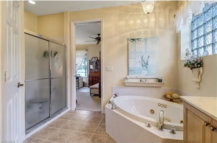 Bathroom featuring tile patterned flooring, plenty of natural light, ceiling fan, and vanity