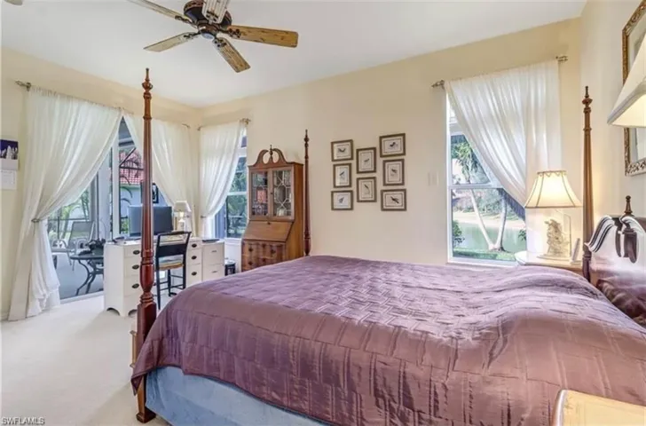 Carpeted bedroom with ceiling fan