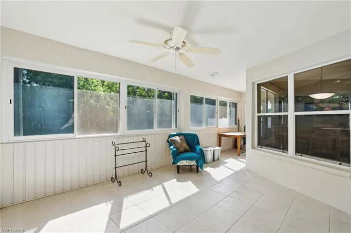 Unfurnished sunroom with a ceiling fan