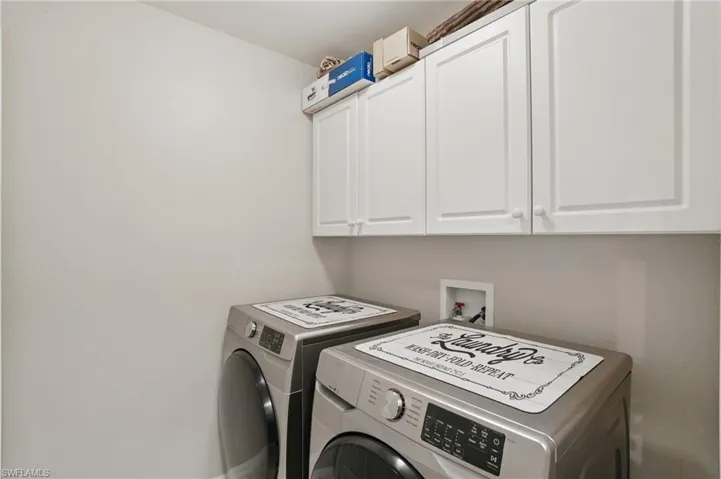Clothes washing area with cabinet space and washing machine and clothes dryer