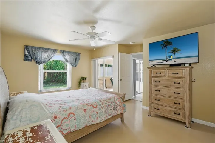 Bedroom with baseboards, concrete floors, and ceiling fan