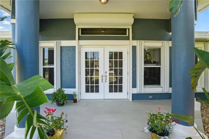 Doorway to property with french doors and stucco siding
