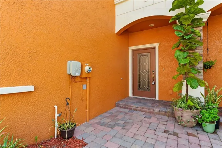 View of exterior entry featuring stucco siding