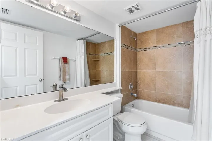 Full bathroom with tiled shower / tub combo and a linen closet.