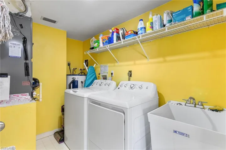 Utility room with full-size washer and dryer, plus a laundry tub!