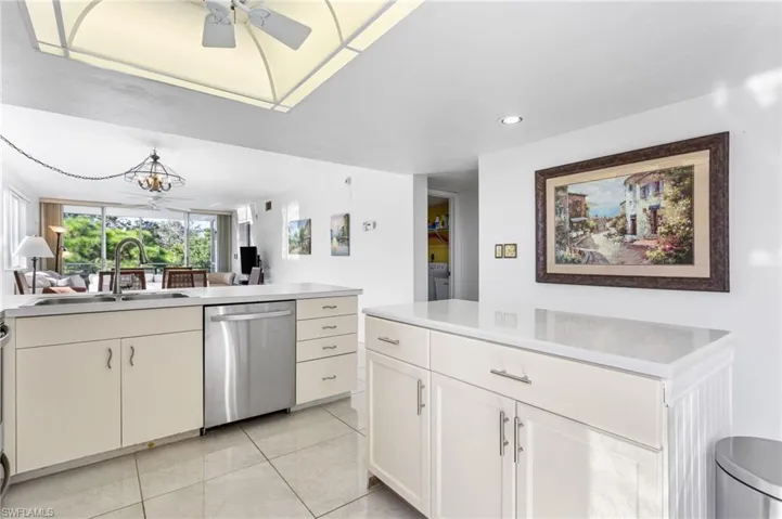 The bright, open kitchen features stainless steel appliances, island and peninsula with room for seating.