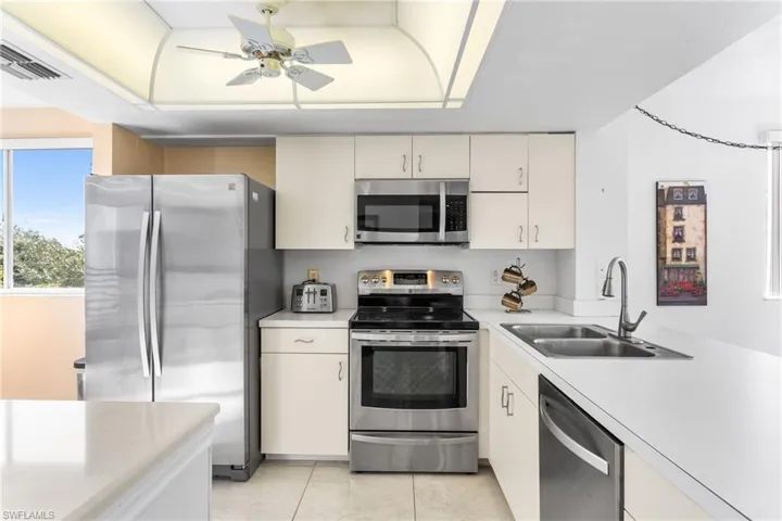 The bright, open kitchen features stainless steel appliances, island and peninsula with room for seating.