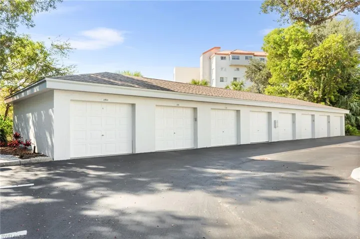 Single-car garage (3rd in from left) provides extra storage and weather protection. With far fewer garages than units in Naples Cove, this is a treasured gem!!