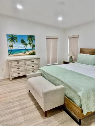 Bedroom featuring light laminate  flooring and recessed lighting