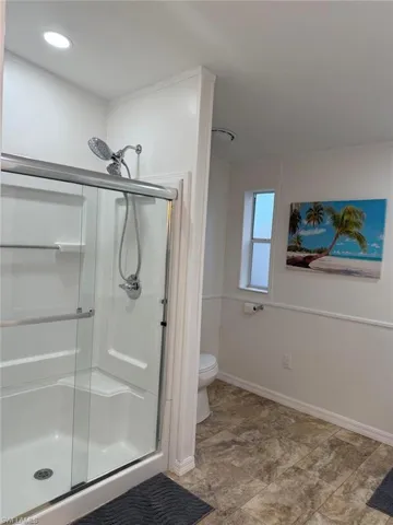 Bathroom featuring a stall shower and toilet