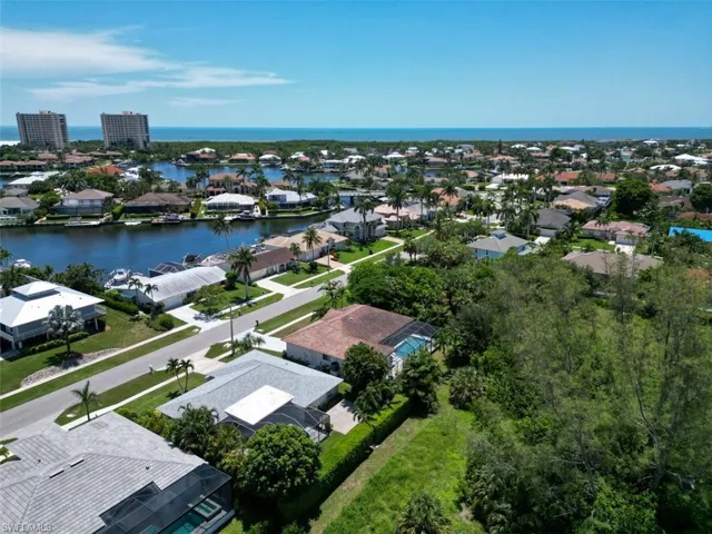 Aerial perspective of suburban area with a large body of water