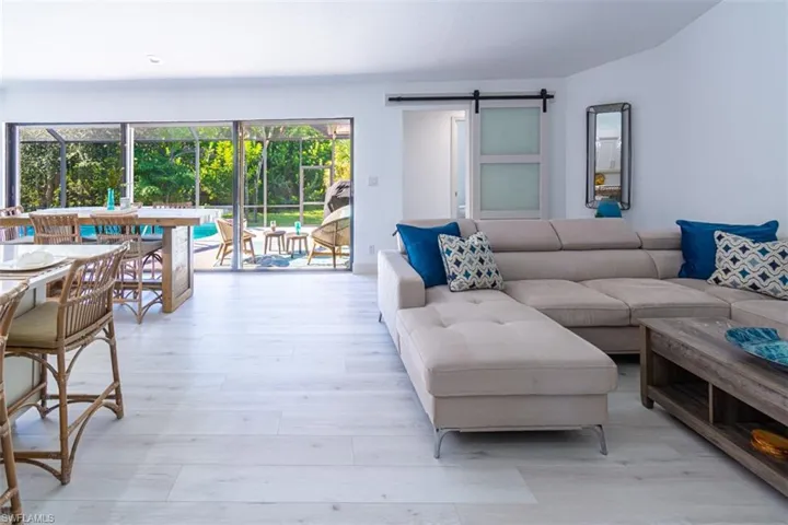 Living room featuring a barn door and light wood-style floors