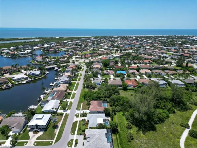 Aerial view of property's location featuring a large body of water and nearby suburban area