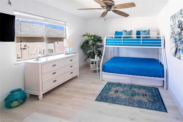Bedroom with light wood finished floors and ceiling fan