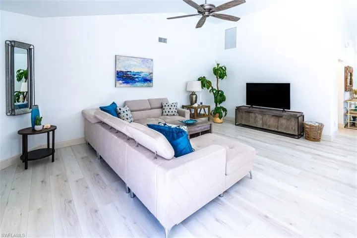 Living room with light wood finished floors and a ceiling fan