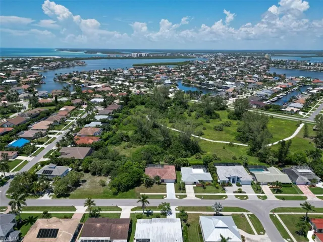 Aerial view of property's location with nearby suburban area