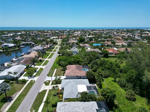 View of property location featuring a nearby body of water and nearby suburban area