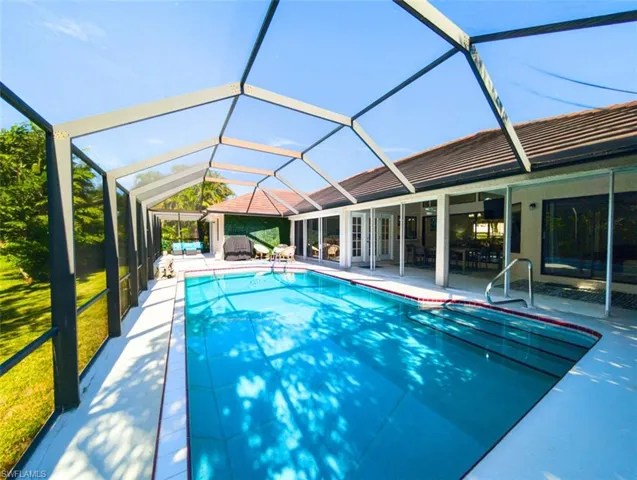 Outdoor pool with a patio and a lanai