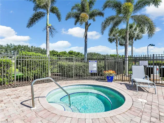 View of swimming pool with a community hot tub