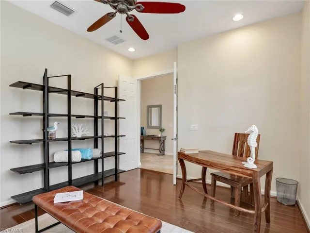 Office space with ceiling fan, wood finished floors, baseboards, and recessed lighting