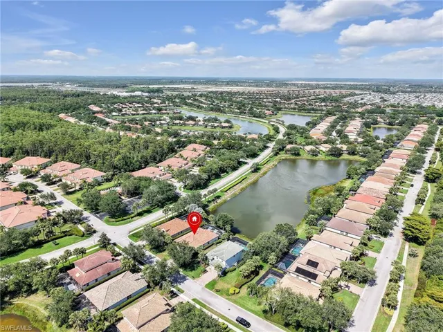 Aerial view of property's location featuring nearby suburban area and a large body of water