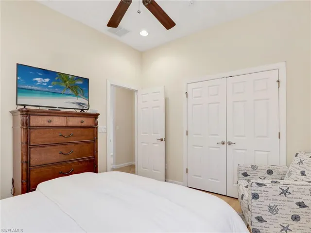 Bedroom with a closet, ceiling fan, and baseboards
