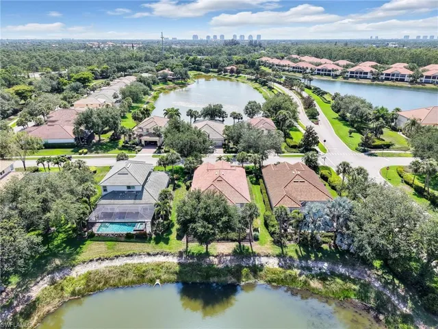 Aerial view of residential area with a large body of water and city skyline