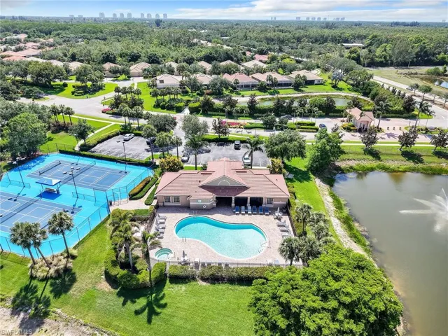 Drone / aerial view of a pool area and a large body of water