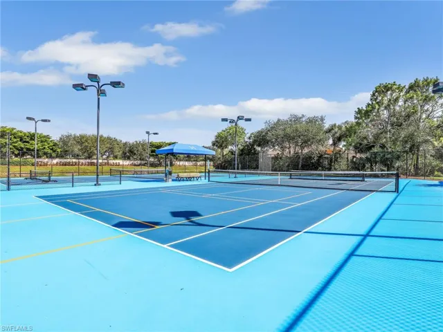 View of tennis court with community basketball court