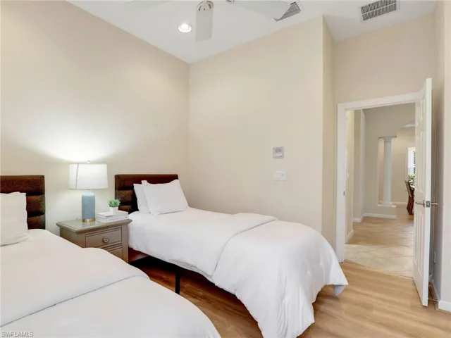 Bedroom featuring light wood-style flooring, ceiling fan, and baseboards