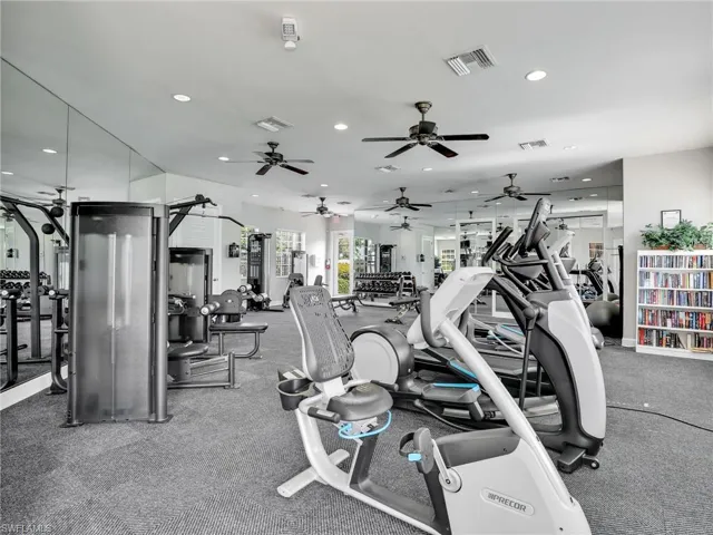 Workout area with recessed lighting and a ceiling fan