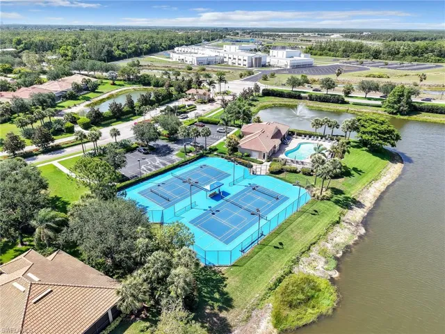 Bird's eye view of a nearby body of water and a pool area