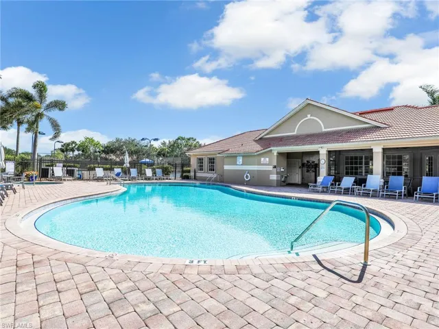 Community pool with a patio