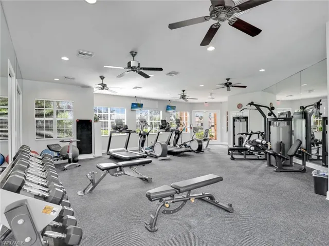 Gym with recessed lighting, baseboards, and a ceiling fan